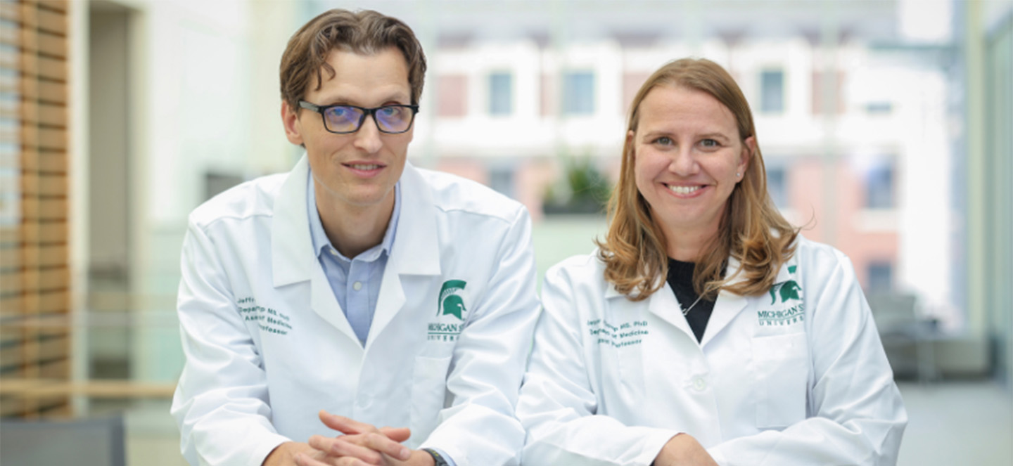 Jeff Klomp and Jenny Klomp wearing lab coats