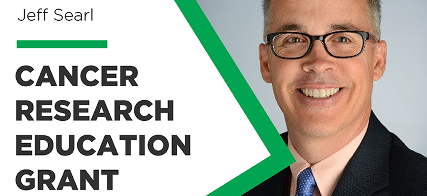 Cancer Research Education Grant logo over a smiling Jeff Searl