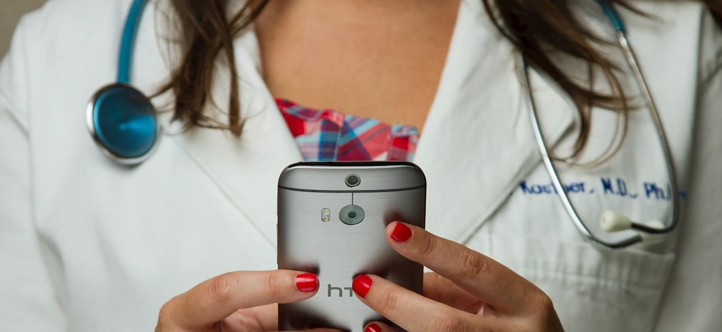 A doctor texting on smartphone