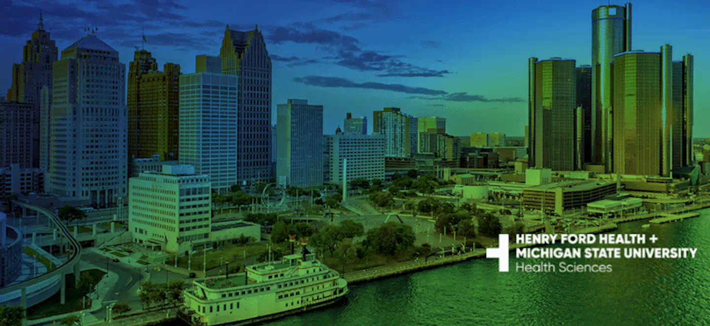 Henry Ford Health + Michigan State University Health Sciences logo over a city