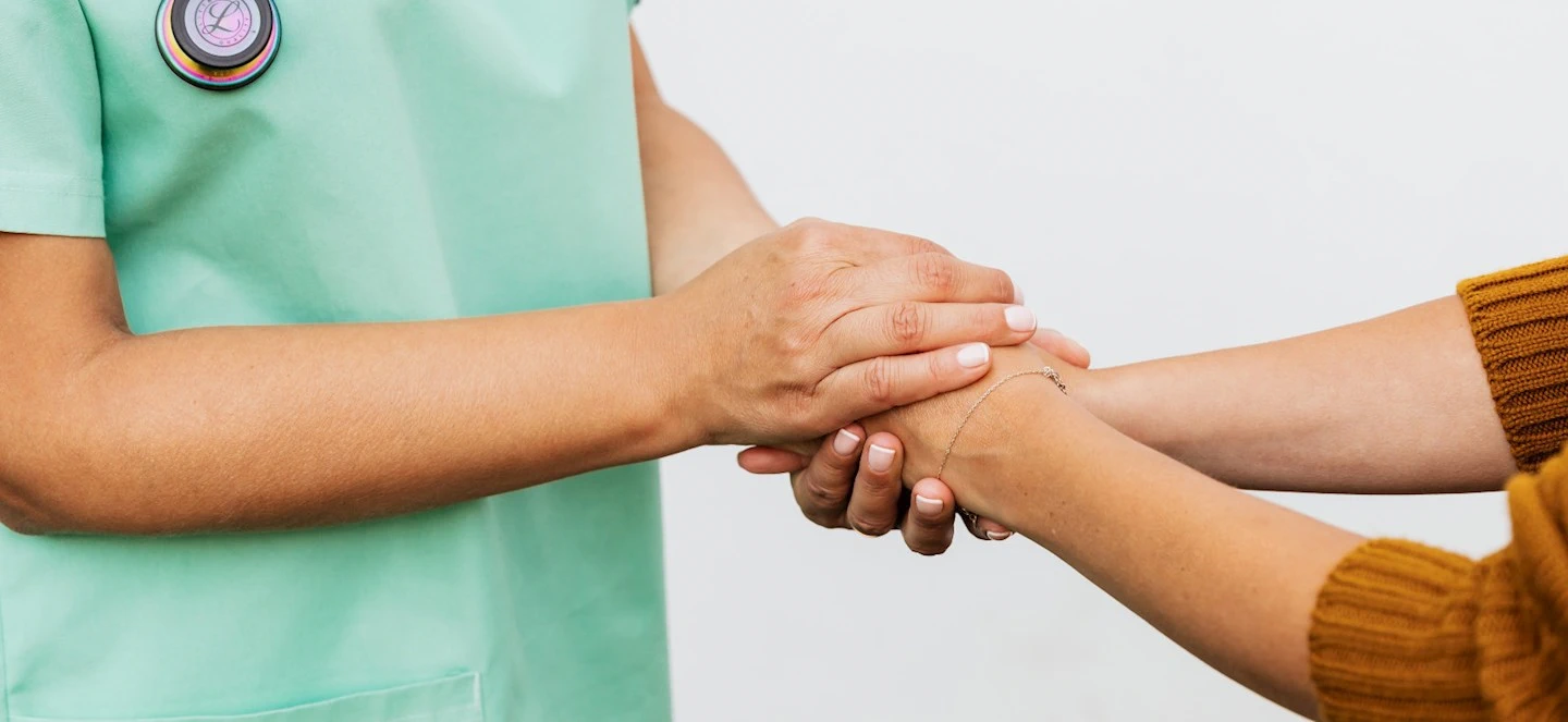 A person cupping their hands over another persons hands