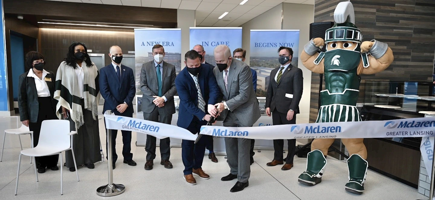 McLaren and MSU representatives both cutting ribbon