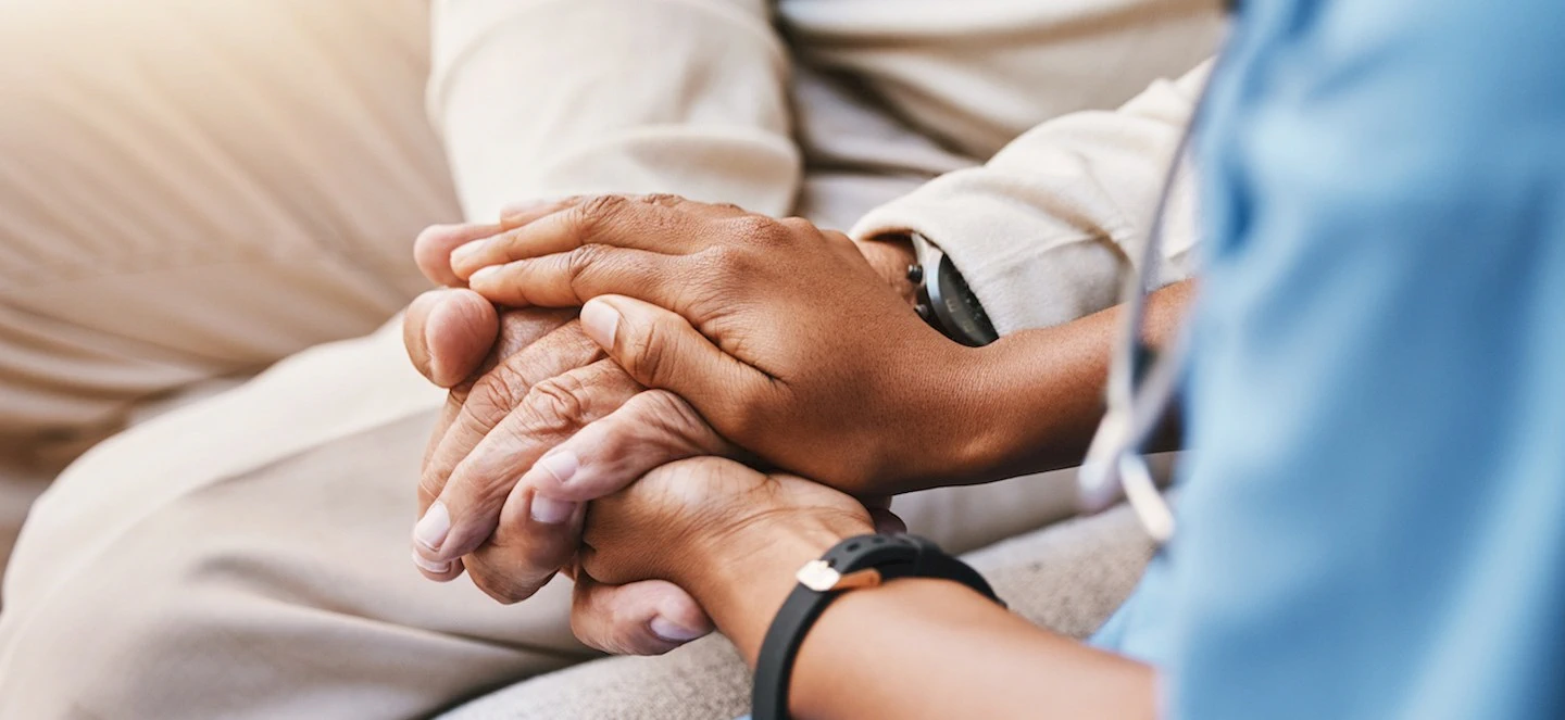 A person cupping their hands over another persons hands