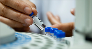 Hands holding a test vial