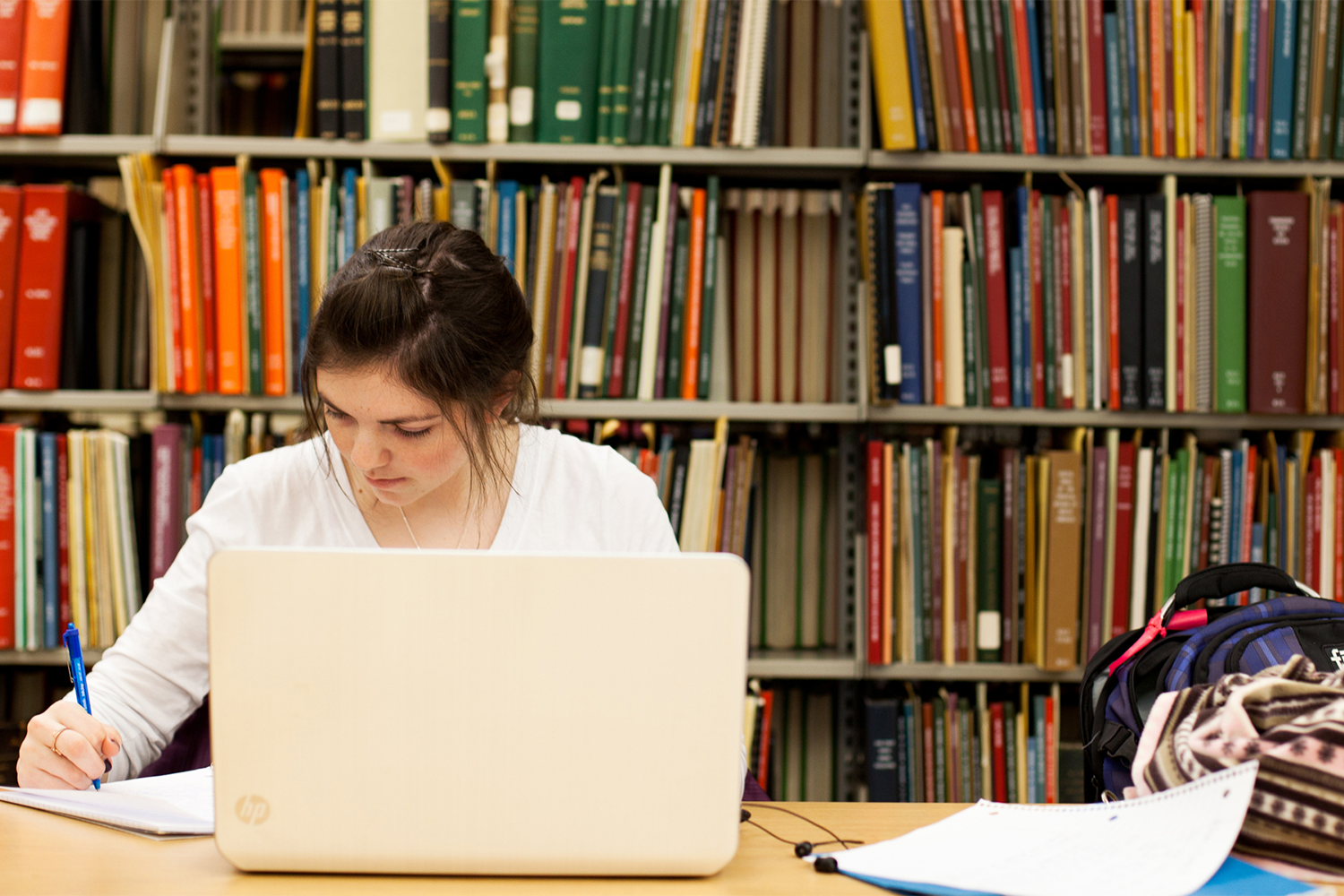 A student sitting in a library studying