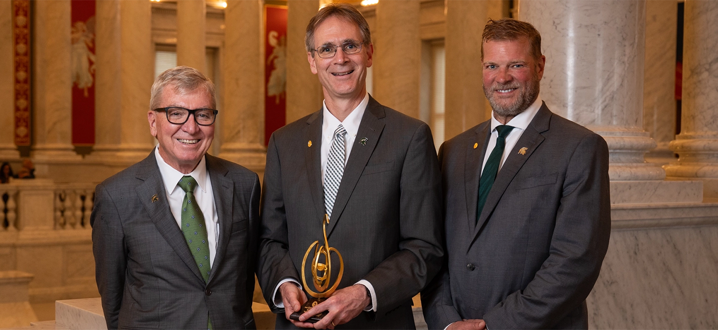 Doug Gage, Eric Hegg, Thomas Jeitschko holding the golden goose award.