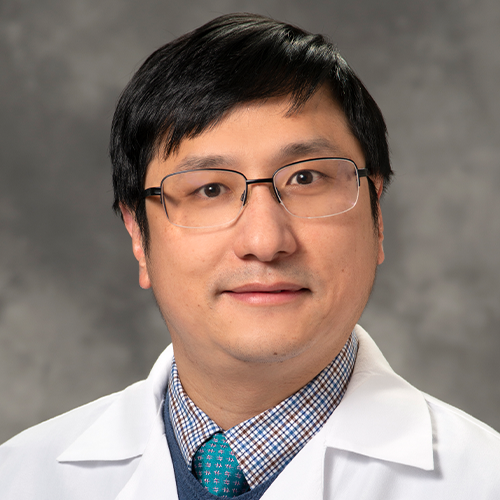 A headshot of Ling Huang wearing glasses and a lab coat. 