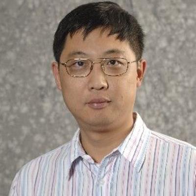 A headshot of Kefei Yu wearing glasses and a pastel dress shirt